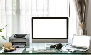 Modern home office with computer and laptop