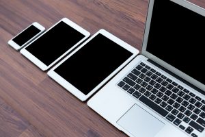 laptop with tablet and smart phone on table