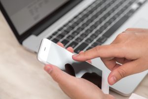 Woman hand hold smart phone with blank empty screen